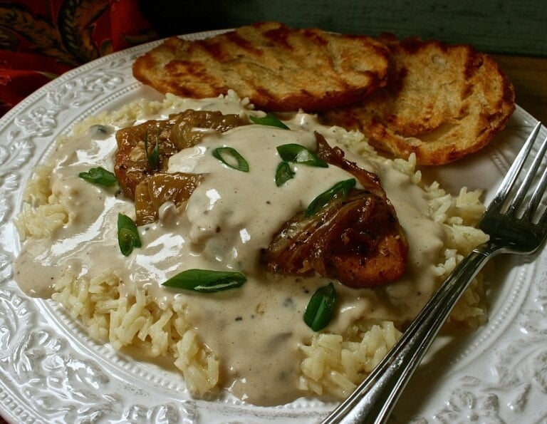 Spoon Tender Pork Chops and Gravy Over Rice